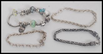 A collection of silver / white metal bracelets to include Miss Fox charm bracelet, stone set 925,