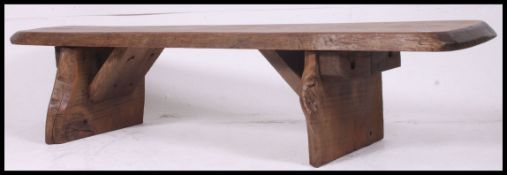 A large rustic / farmhouse vintage bench of tree - plank form in oak being well polished.