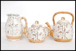 A Victorian Majolica large and small teapot together with matching water Jug in a bamboo style