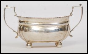 A solid silver twin handled large sugar bowl.