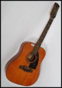 A vintage EKO 12 string acoustic guitar, with bone fret inlays and gilt EKO plaque to top.