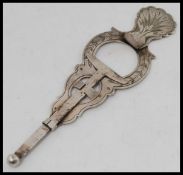 A silver plated continental egg topper with moving action and chase decorated finish