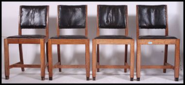An excellent set of 4 1930's oak and leather panel back dining chairs.