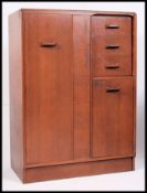 A 1960's Ernest Gomme G-Plan tallboy - bachelors wardrobe consisting of hanging cupboard with