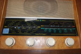 A vintage Bush UK, valve radio, original wooden case with logo to top and dials to front.