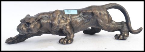 A 20th century cast iron lion figure - depicting a hunting lioness,