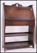A 1920's Liberty Arts & Crafts style oak students bureau having fall front bureau over bookcase