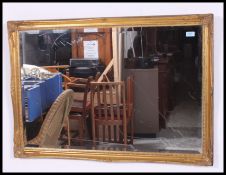 An early 20th century over mantle gilt framed wall mirror having foliate molding's to the frame.