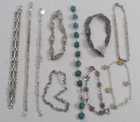 A collection of 10 ladies contemporary silver bracelets.