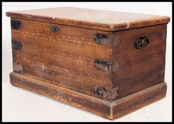 A Victorian scrumble finished pine blanket box chest with hinged top and plinth base.