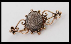 A Victorian 9ct gold and agate stone set ladies brooch.