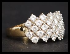 A ladies 14ct gold  / 585 hallmarked pave set cocktail dress ring. The clear stones being pave set.