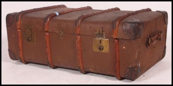 An excellent oversized large canvas and wooden bound early 20th century steamer trunk. Monogram W.E.