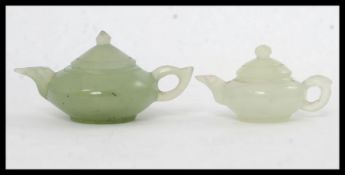 2 carved Jade Chinese miniature teapots. Each with lids and shaped handles Largest H8.