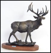 A large and impressive cast metal bronze effect statue of a stag.