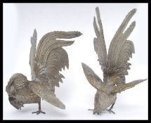 A pair of 20th century large white metal fighting cocks ornaments ( see illustrations ) H24cm