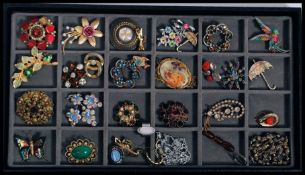 A collection of assorted vintage costume jewellery to include brooches, watches etc.