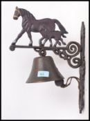 A 20th century cast metal wall hanging bell,