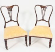 A Pair of ( 2 ) Victorian rosewood, mahogany and marquetry inlaid nursing chairs.