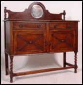 A 1930's golden oak mirror back barleytwist sideboard.