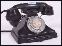A vintage mid 20th century GPO bakelite telephone having a recent conversion with contacts drawer