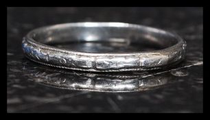 A 20th century Platinum band ring of plain simple form with banded chase decoration. Total weight 3.
