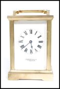 A Garrard of London 20th century presentation brass carriage clock complet, with key.