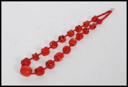 A white metal (marked 925 indicating silver ) and coral ladies necklace.