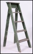 A painted mid century shabby chic Industrial step ladder in original green paint finish.