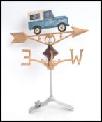 A 20th century weathervane and mount, with Land Rover painted figure to top.