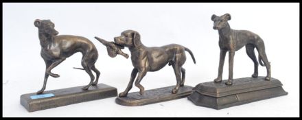 A collection of 3x small cast iron statues of dogs