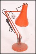 A retro 1970's Herbert Terry Industrial anglepoise desk lamp in orange with circular base and