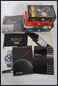 A collection of watch brochures to include Breitling etc together with another collection of