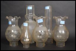 A collection of oil lamp shades to include a good frosted shade of unusual form and a matching set