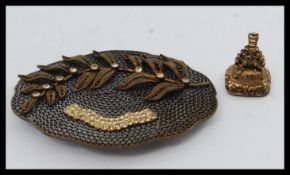 An unusual vintage mid century large filigree brooch adorned with leaf and stones. Pin to verso.