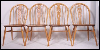 A set of four contemporary light elm seat and beech wheelback chairs,