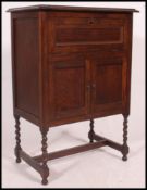 A 1920's oak cased gramaphone cabinet being raised on turned legs with hinged top ( no gramaphone )