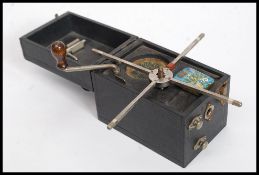 A vintage early 20th century Dixonia miniature portable gramaphone in black vinyl box case ( see