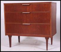 A good retro 1970's teak chest of drawers raised on tapered supports with blind front drawers.