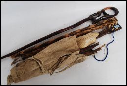 A collection of African carvings to include a musical instrument in a skin case, a small mandolin,