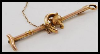 A 9ct gold ladies fox hunting bar brooch.