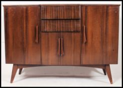 A vintage retro 1950's sideboard with sloping front drawers having central twin central door
