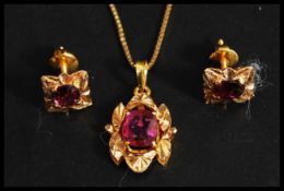 A 22ct gold and ruby pendant necklace set to an 18ct gold chain.