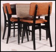 A 1950's Melamine drop leaf square dining table raised on tapered legs with melamine top and drop