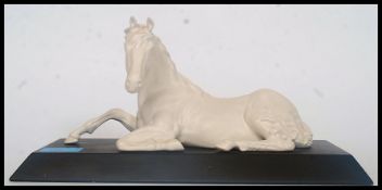 A good quality Beswick ceramic white horse figurine raised on a plinth.