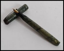A vintage 20th century Mentmore Supremen Lever Fill Fountain Pen  having snakeskin effect cap and