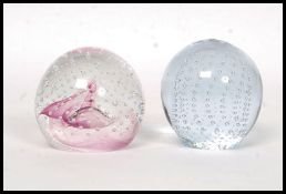 A later 20th Century Caithness paperweight titled Pink Champagne having an internal powder pink and