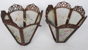 A pair of Chinese hardwood and glass ceiling lanterns. The panels with decorative scenes.