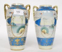 A pair of 20th Century Kinjo china hand painted twin handled Nippon vases decorated with landscape