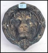 A Victorian style cast iron large door knocker, in the form of a lions head.